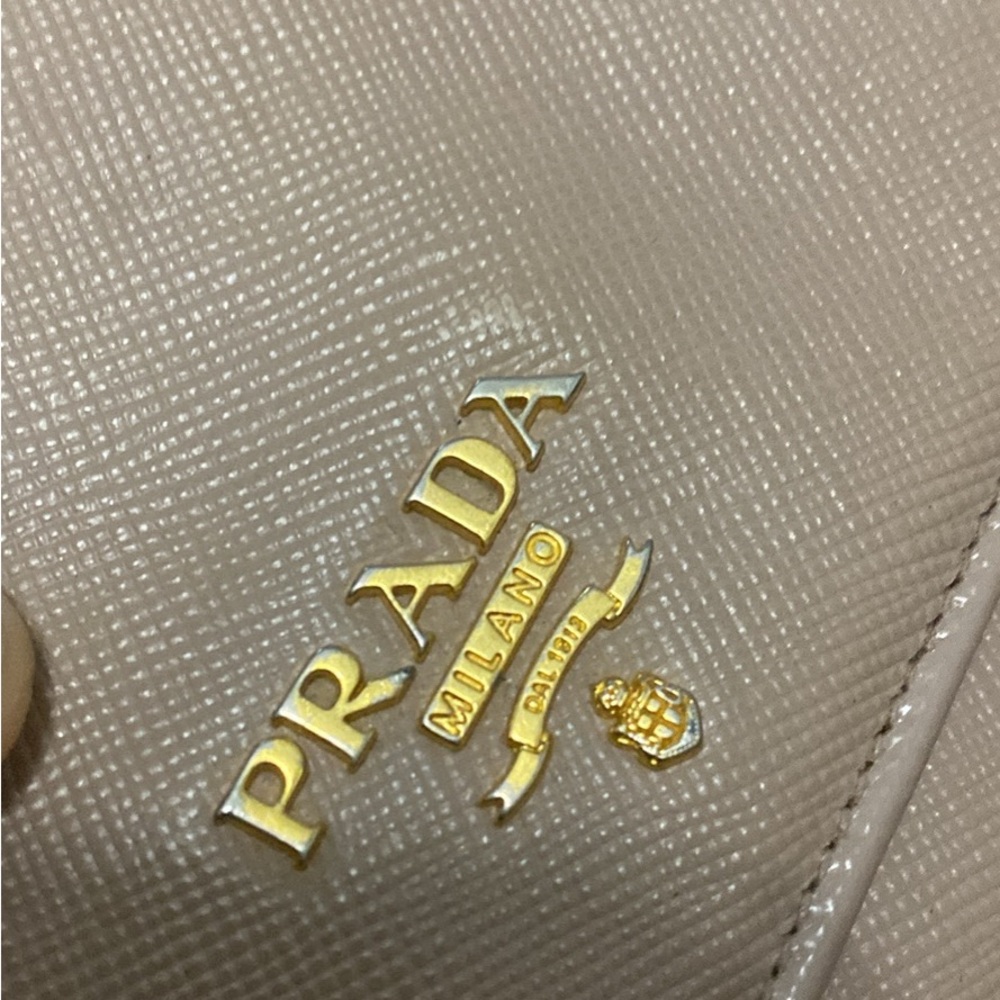 Preowned Beige Prada wallet w/ gold on inside